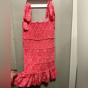 Pink patterned dress with bows on the shoulders.